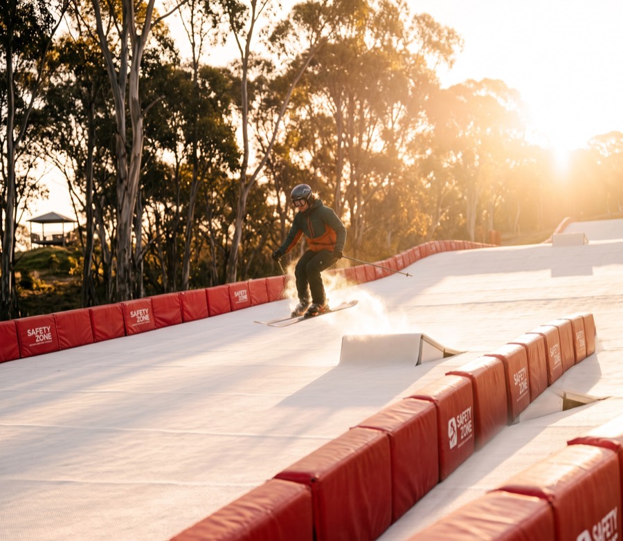 A skier landing off a kicker on the features line
