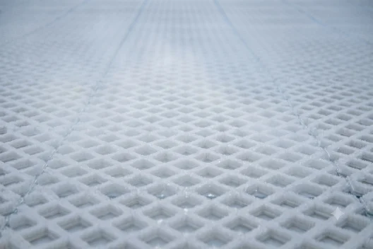 Close-up of the interlocking dry-slope matting that forms the riding surface